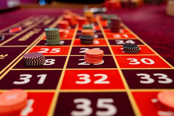 Live baccarat table at mansion studio with visible card shoe and croupier